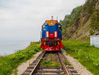 Train on railroad track against sky