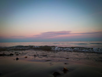 Scenic view of beach against sky during sunset