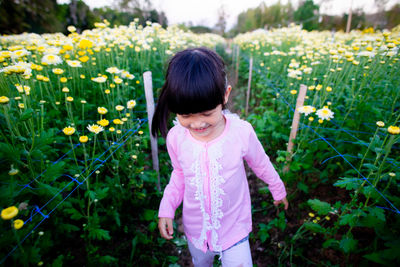 Girl standing by flowering plants