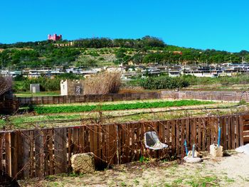 Houses on field against clear sky