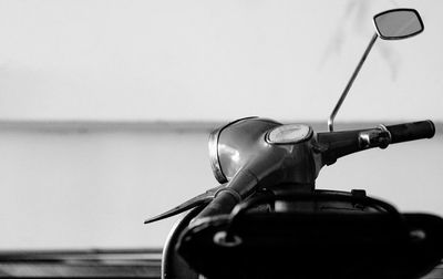 Close-up of bicycle wheel by sea against sky