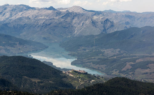 High angle view of land and mountains against sky