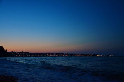 Scenic view of sea against clear sky at sunset