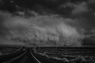 Panoramic view of road against storm clouds