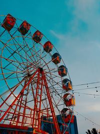 Low angle view of ferris wheel against sky