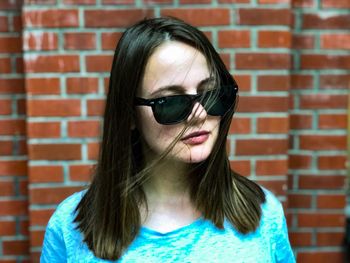 Portrait of woman against wall