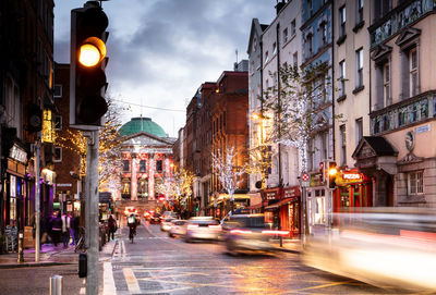View of city street and buildings at night
