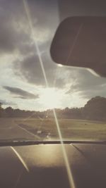 Sun shining over road