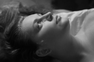 Close-up portrait of boy lying on bed