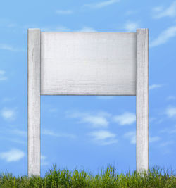 Low angle view of metallic structure on field against sky