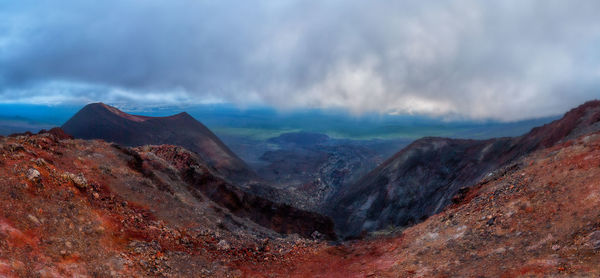 View of volcanic mountain against cloudy sky