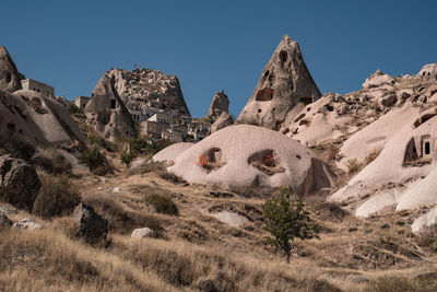 Rock formations on landscape against clear sky