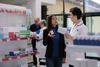 Portrait of female friends standing in store