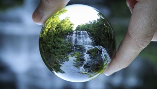 Close-up of human hand holding crystal ball