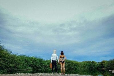 Silhouette of woman standing by tree