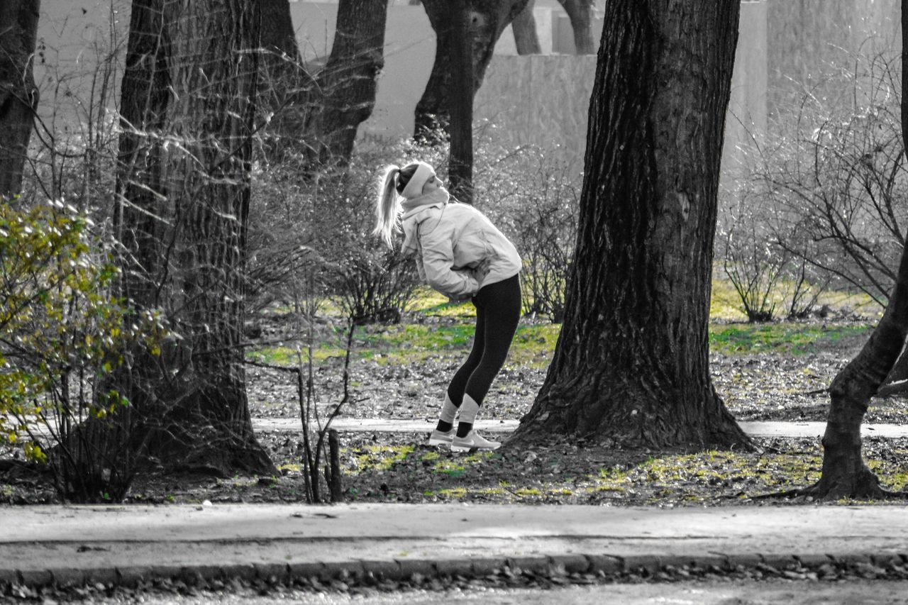 MAN WALKING BY PLANTS