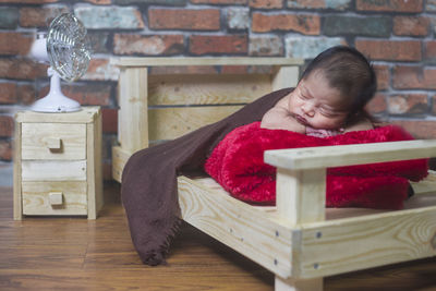 Cute girl sitting on sofa at home
