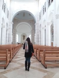 Rear view of woman walking in temple