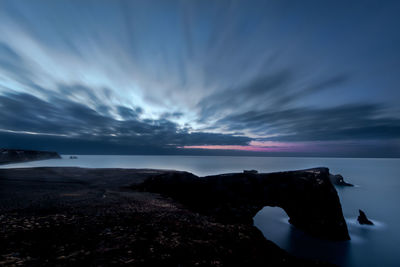 Scenic view of sea against sky dyrhólaey rock formation at sunrise 