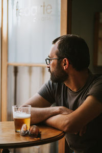 Midsection of man sitting at table