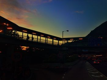 Surface level of illuminated road against blue sky