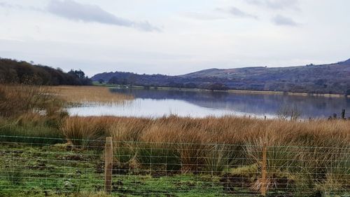 View of lake against cloudy sky