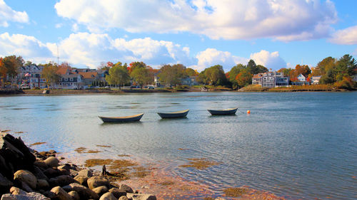 View of boats in city at sunset