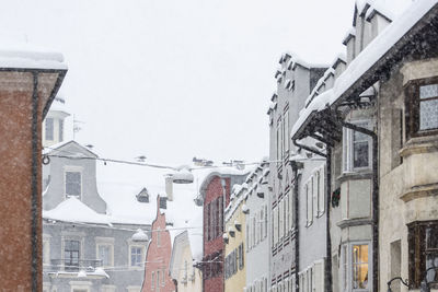 Low angle view of buildings against sky during winter