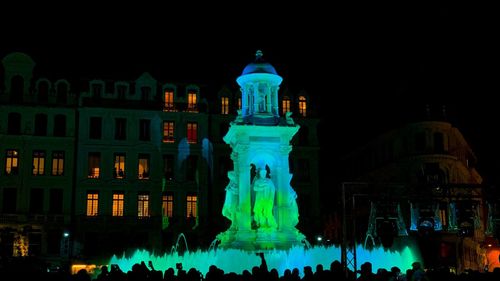 Statue of illuminated building at night