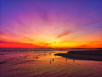 Scenic view of beach against sky during sunset