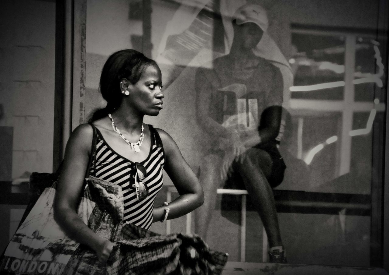 PORTRAIT OF YOUNG WOMAN STANDING ON GROUND