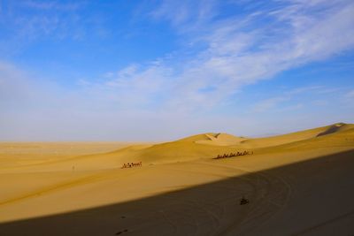 Scenic view of desert against blue sky