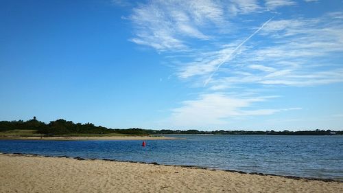 Scenic view of beach against blue sky