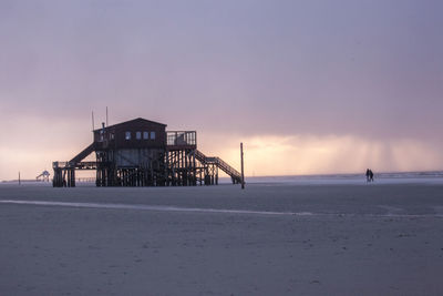 Scenic view of beach against sky during sunset