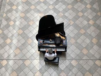 A musician plays the piano at a posh shopping mall in makati city, metro manila. high angle view. 