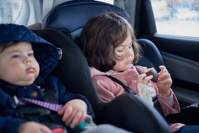 siblings in car