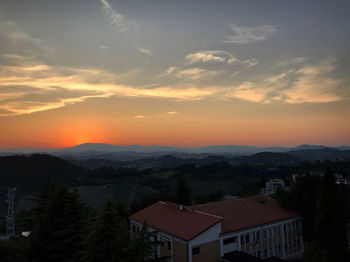 High angle view of buildings against sky during sunset