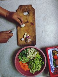 High angle view of person preparing food on cutting board