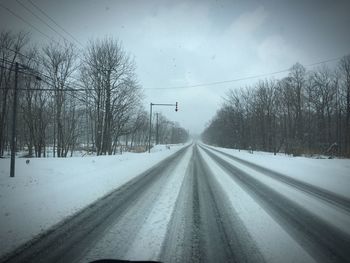 Road passing through snow covered landscape