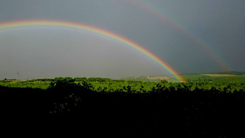 Scenic view of rainbow over field