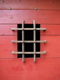 Close-up of window on red wall