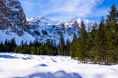 Scenic view of snow covered mountains against sky