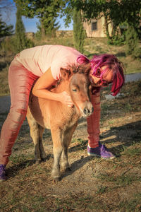 Full length of woman with foal