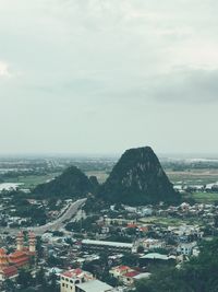 High angle view of town by sea against sky