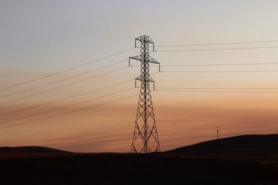 Low angle view of electricity pylon against sky