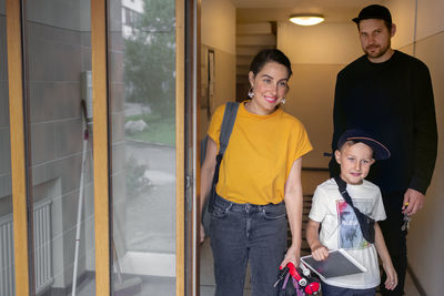 Portrait of friends standing at home