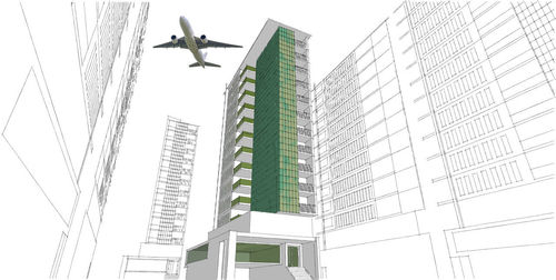 Low angle view of airplane flying in building against sky