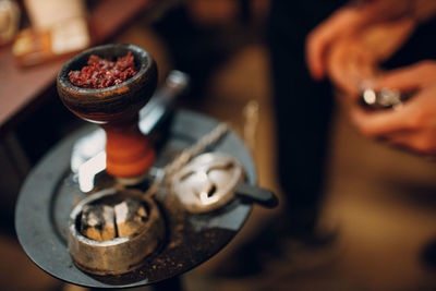 Close-up of hand holding coffee cup