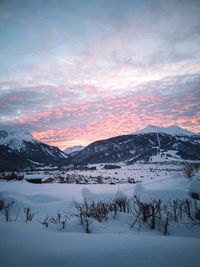 Scenic view of snowcapped mountains against sky during sunset