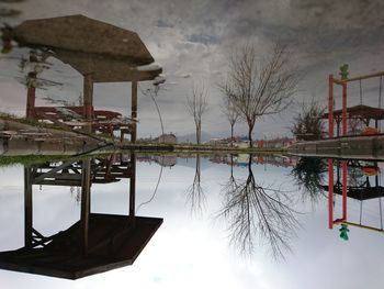 Reflection of building on lake against sky